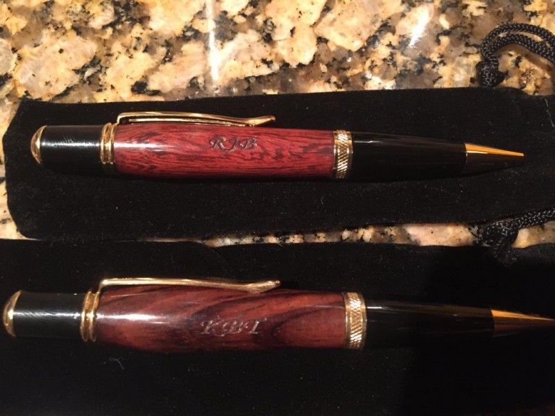 A pair of pens with initials.